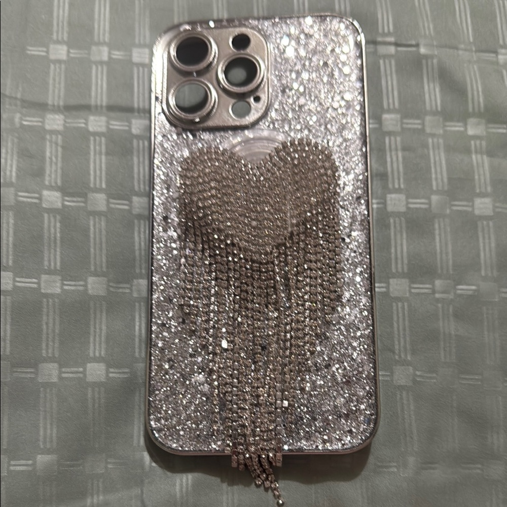 Glamorous Silver iPhone Case with Heart Tassel Design for Iphone 15 Pro Max.